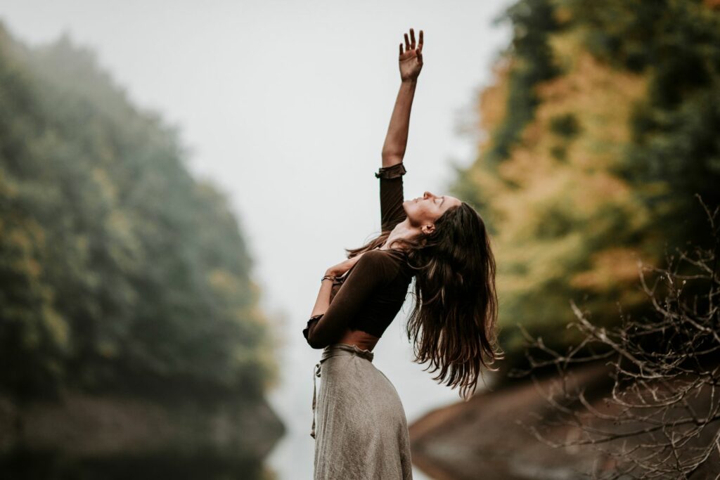 A woman near a river participating in therapeutic exercises.